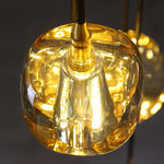 Close-up of an amber crystal chandelier shade with a warm glowing bulb