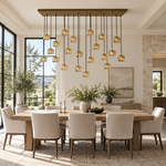 Brass cascade chandelier with glowing crystal shades above a dining table