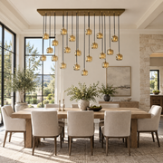 Brass cascade chandelier with glowing crystal shades above a dining table